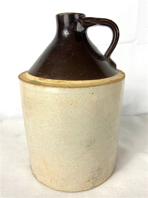 The primitive brown antique stoneware pottery jug is in good condition. . Old crock jug